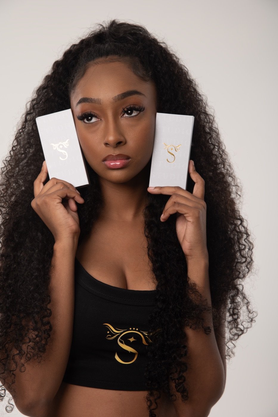 A client holding two lash boxes